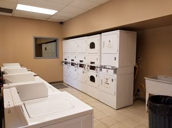 A laundry room with washers and dryers.